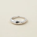 Hammered tapered band ring in silver-tone with faceted texture and rounded edges