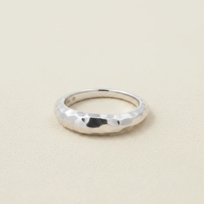 Hammered tapered band ring in silver-tone with faceted texture and rounded edges