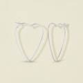 Heart-shaped wire hoop earrings, silver-tone, heart outline with stud closures