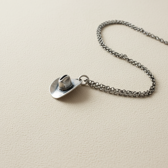 Silver-tone cowboy hat pendant necklace with circular hat charm on link chain