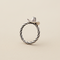 Silver cowboy hat ring with braided rope band and dark swirl detailing