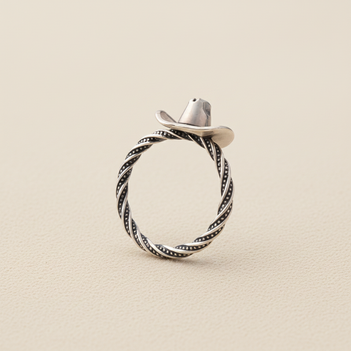 Silver cowboy hat ring with braided rope band and dark swirl detailing