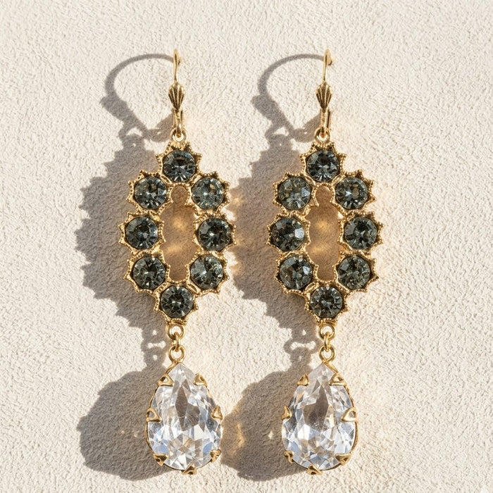 Gold-tone chandelier earrings with dark faceted clusters and teardrop clear crystals