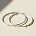 Pair of silver-tone infinite-loop bangle bracelets, overlapping open circles