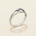 Silver-tone interlocking loops ring with braided loop detail, smooth band