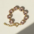 Blush beaded bracelet with gold heart clasp and link chain