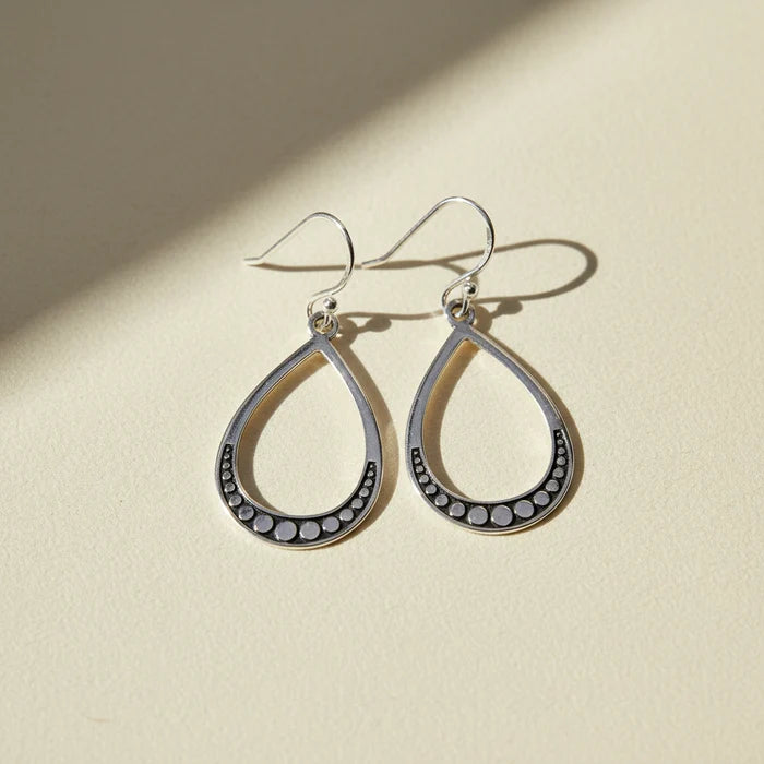 Large silver teardrop beaded earrings with dark bead border and hoop hooks