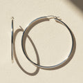 Large sterling silver tube hoop earrings, hinged hoop with smooth cylindrical body.