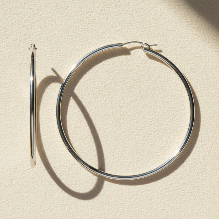 Large sterling silver tube hoop earrings, hinged hoop with smooth cylindrical body.