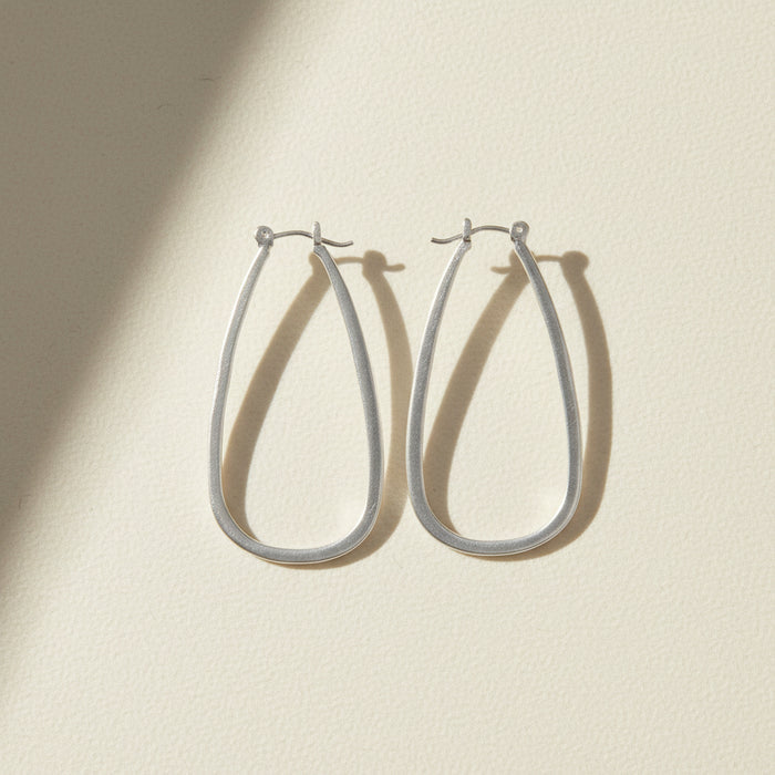 Large silver teardrop hoop earrings with hinge hook closure