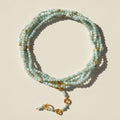 Light aqua bead wrap bracelet/necklace with gold charms and clasp