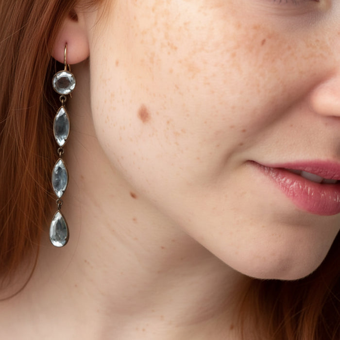 Long drop earrings with mirrored beveled teardrop charms and silver-tone hooks