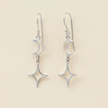 Silver-tone dangle earrings with crescent moon and star charms on linked hooks