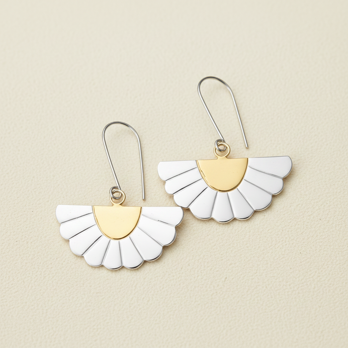 Gold and white fan-shaped drop earrings with scalloped petals, on curved hooks.