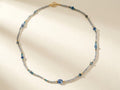 Blue and silver beaded choker necklace with gold clasp and small round teal beads