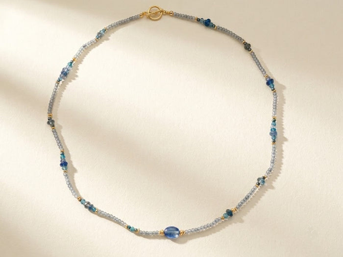 Blue and silver beaded choker necklace with gold clasp and small round teal beads