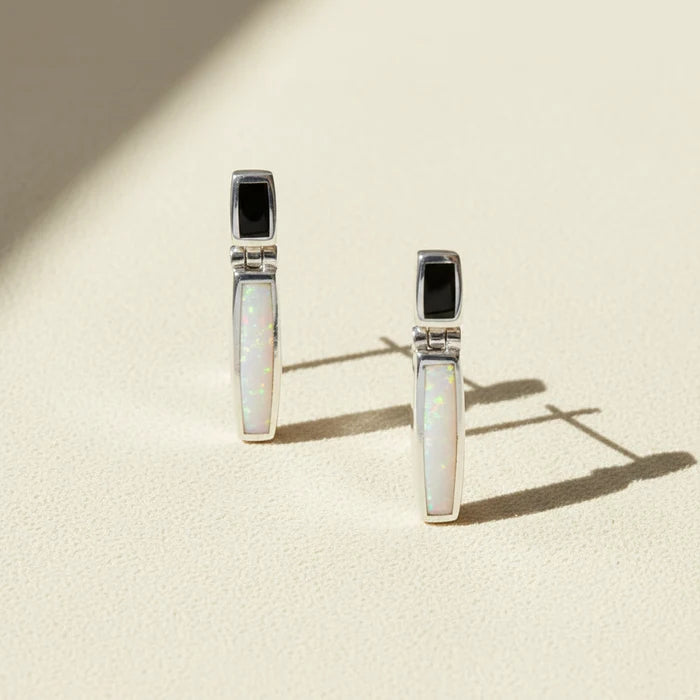 Pair of earrings with opal stones on a white background