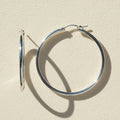 Silver hoop earrings on a white background