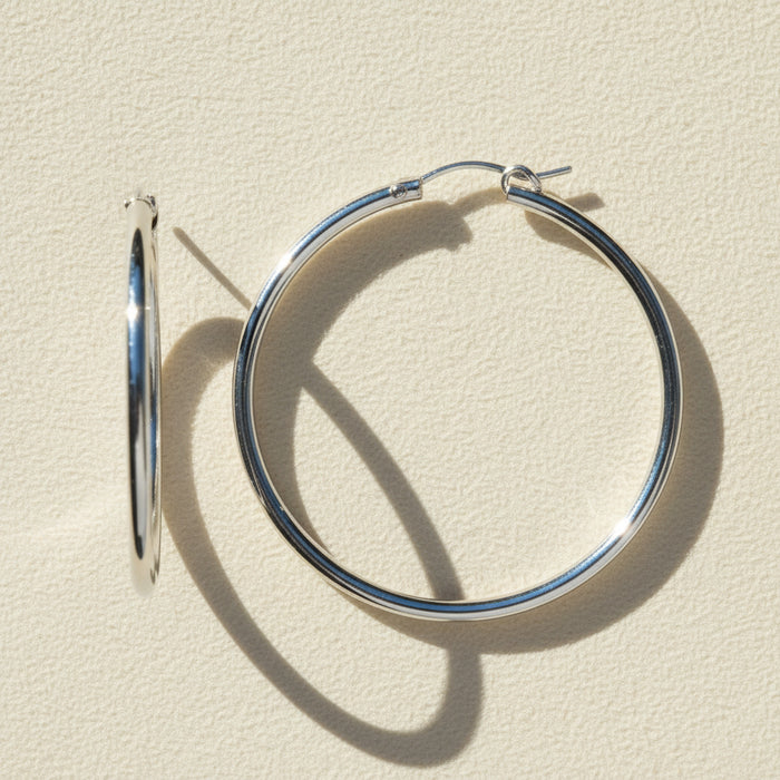Silver hoop earrings on a white background