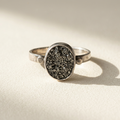 Round druzy ring with black glittery stone bezel and slim silver band
