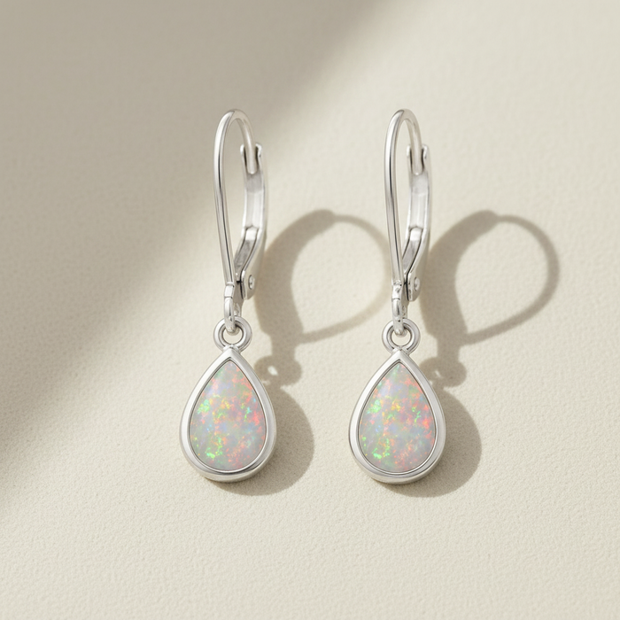 Silver opal teardrop dangle earrings with iridescent opal-like center
