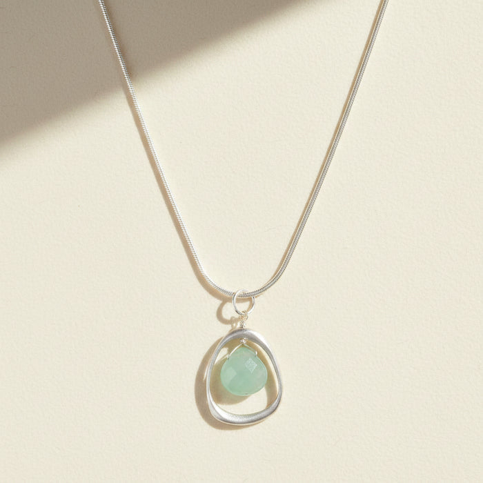 Silver open-circle necklace with teardrop pale green chalcedony pendant
