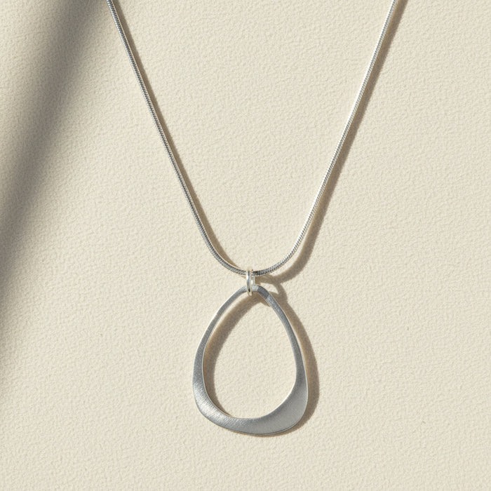 Open drop pendant necklace with open teardrop charm on silver chain