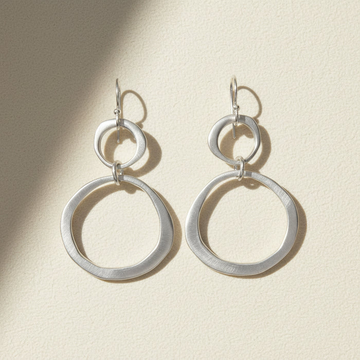 Silver circle drop earrings with small top hoop and large ring drops, lever-back