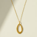 Gold leaf-shaped pendant necklace with slim chain and open teardrop charm