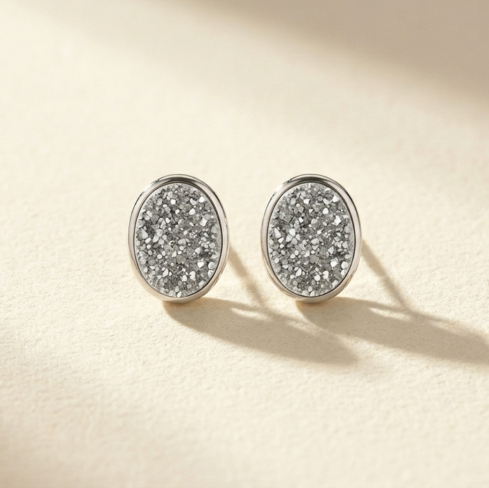 Sterling silver oval druzy stud post earrings, glittering gray crystal texture.