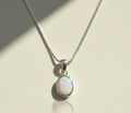 Opal pendant necklace with oval opal stone on silver-tone chain and clasp