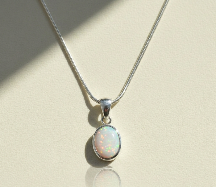Opal pendant necklace with oval opal stone on silver-tone chain and clasp