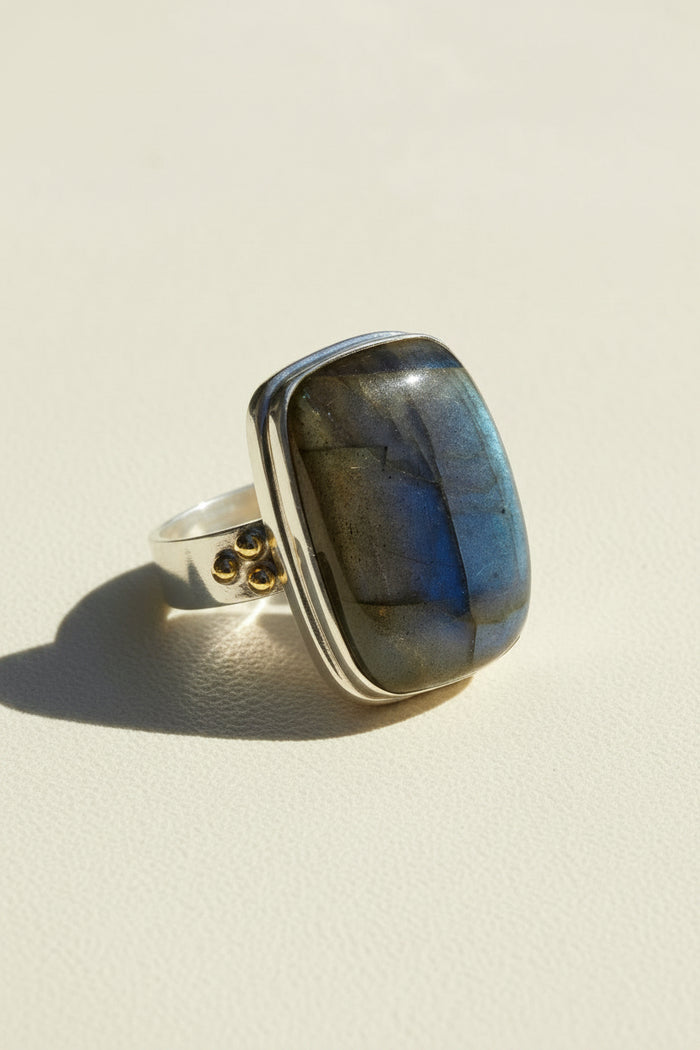 Square blue labradorite ring on a silver band with small brass side details