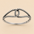 Oxidized knot ring with beaded design and 925 stamp on silver band