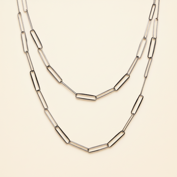 Layered paperclip-link chain necklace with curved bar links, silver-tone.