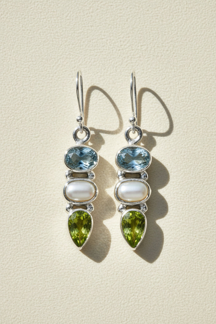 Silver-tone dangle earrings with blue gem, pearl drop, and green teardrop accents