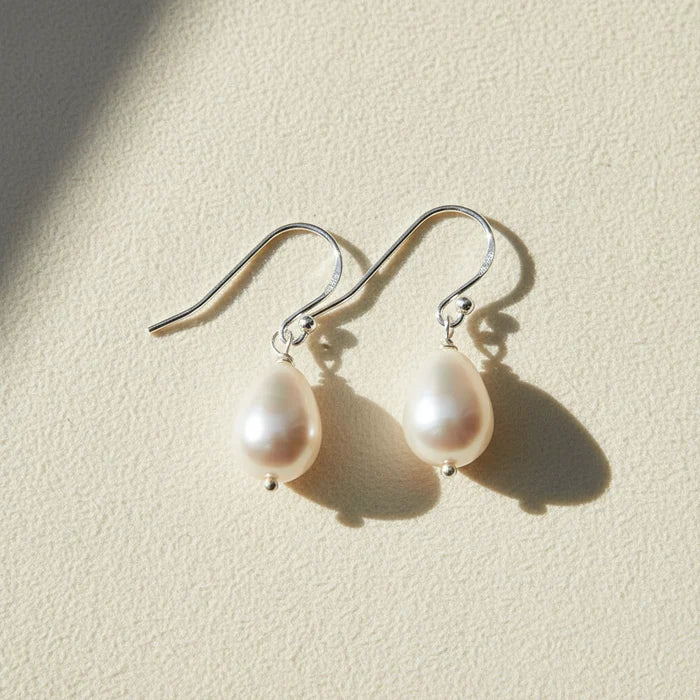 Pearl drop earrings on a white background