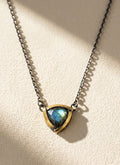 Tri-fold pendant necklace with dark chain and blue-green teardrop stone