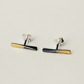 Bar stud earrings with black enamel and gold edge stripes, silver-tone backs