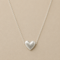 Silver-tone heart pendant necklace on a fine chain