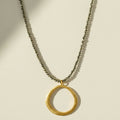 Gold open-circle pendant necklace with short chain and circular charm at center