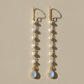Gold-tone moonstone and pearl dangle earrings with oval blue drop and layered pearls