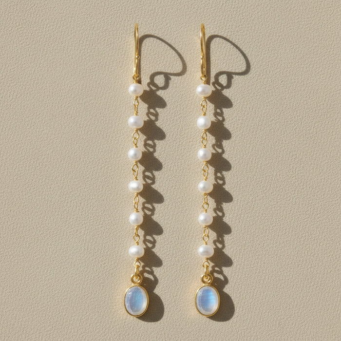 Gold-tone moonstone and pearl dangle earrings with oval blue drop and layered pearls
