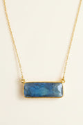 Necklace with a blue stone pendant on a white background