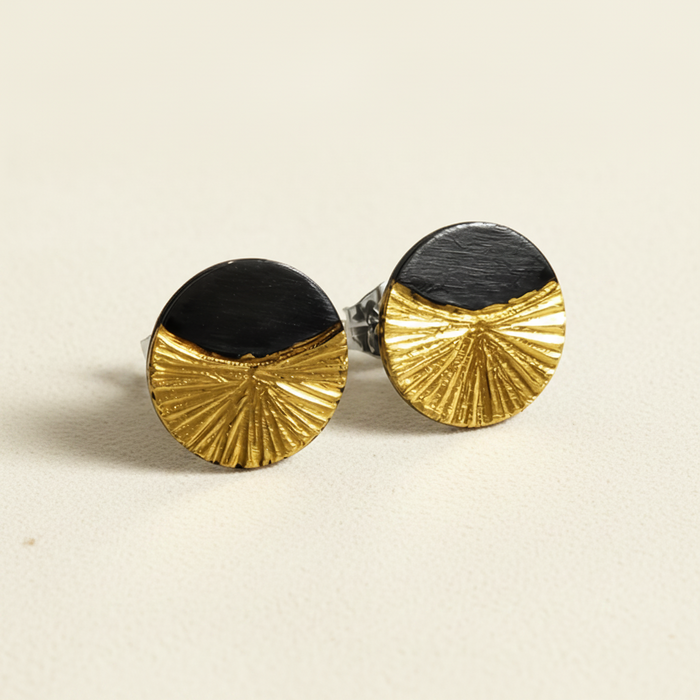 Round black-and-gold stud earrings with radiating fan design and post backs