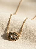 Gold medallion necklace with oval smoky centerpiece on chain