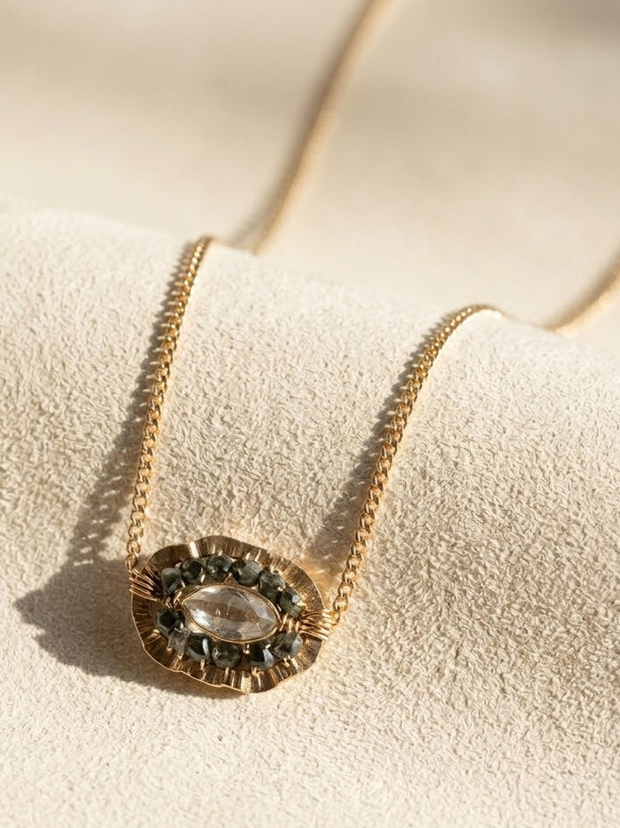 Gold medallion necklace with oval smoky centerpiece on chain