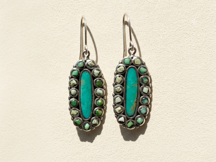 Turquoise oval hoop earrings with green and silver-tone bead accents