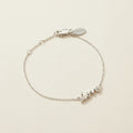 Sterling silver script love bracelet with adjustable clasp and small love charm