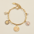 Gold-tone charm bracelet with circular and star charms, crystal accents, clasp links